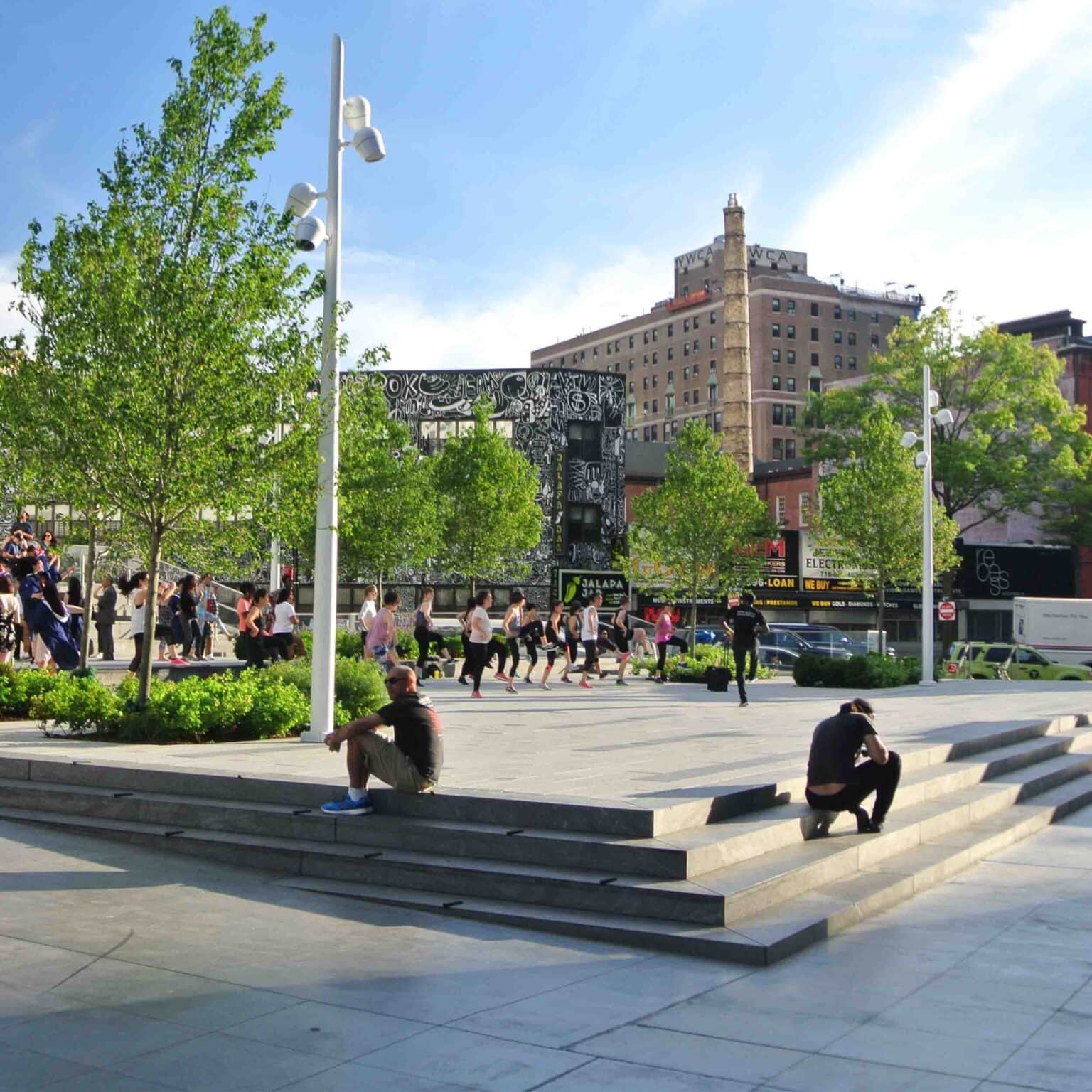 People resting on steps during a public event.