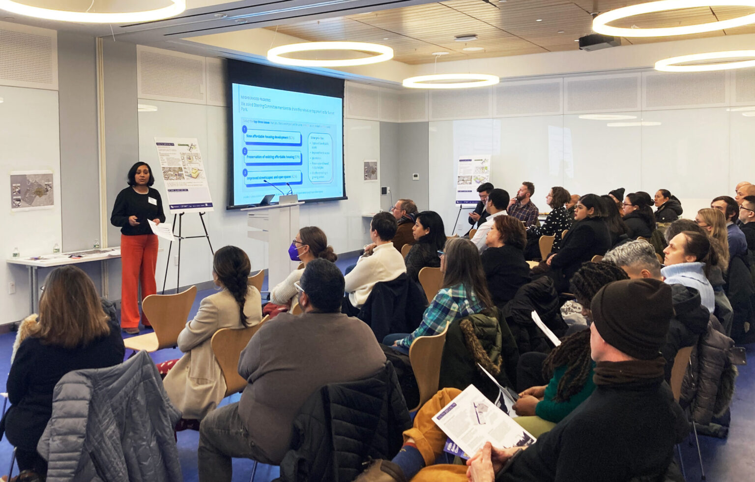 A large group meeting where a the main facilitator is presenting to the community