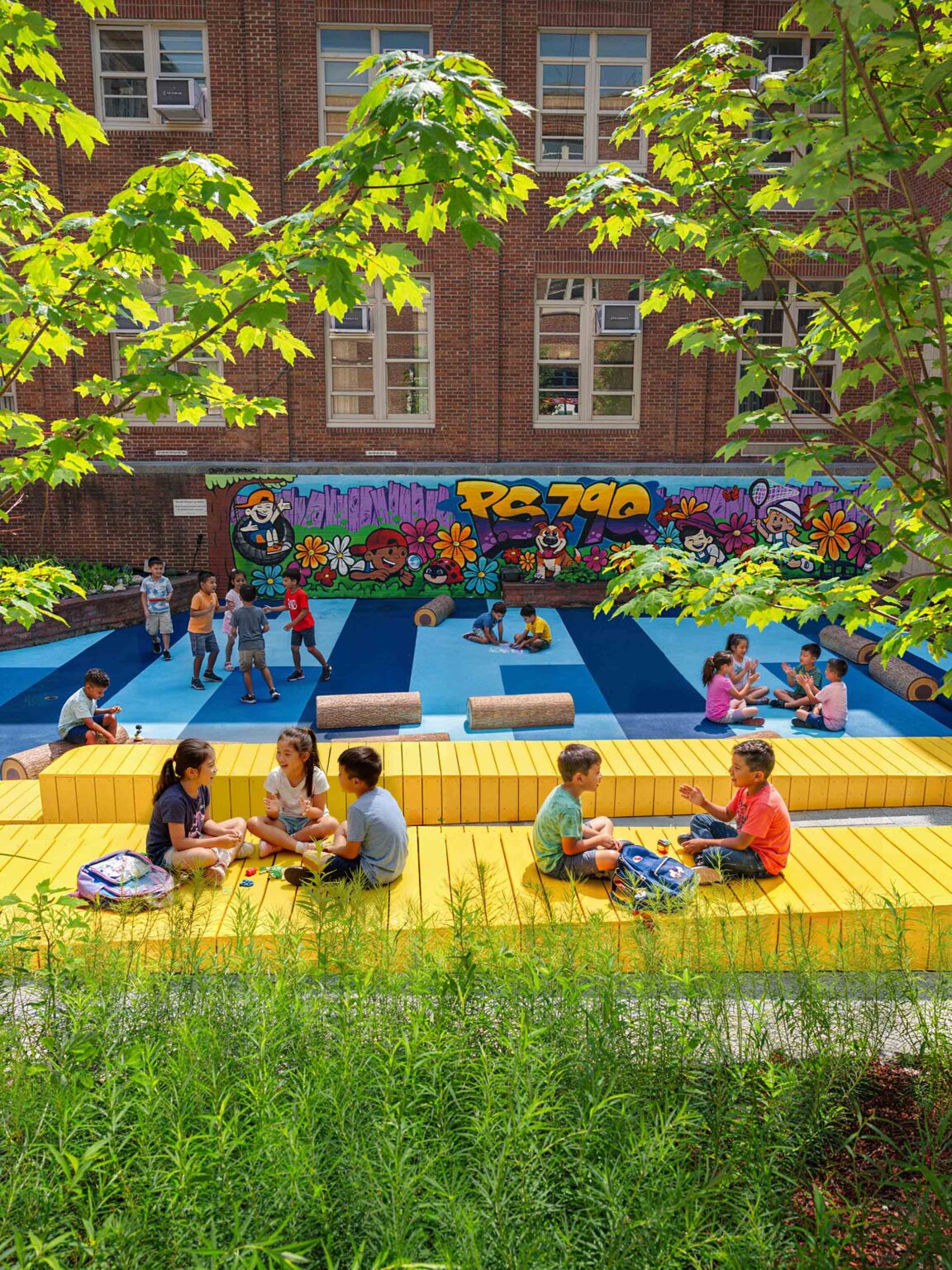 Outdoor classroom with kids sitting on colorful bleacher in colorful school courtyard